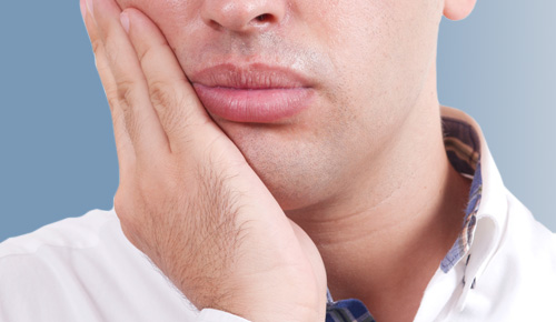 Man Holding jaw in pain