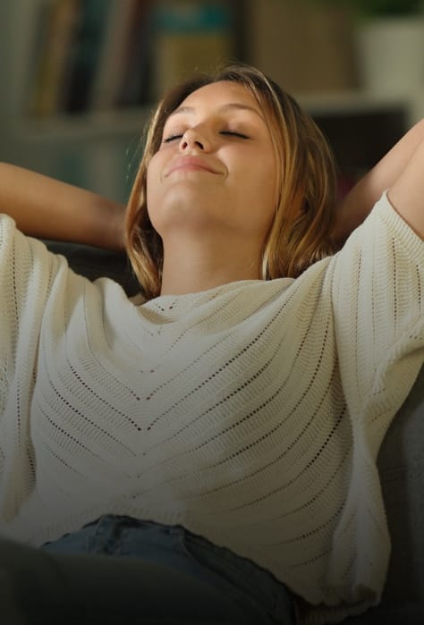 Woman smiling, relaxing, and breathing through nose